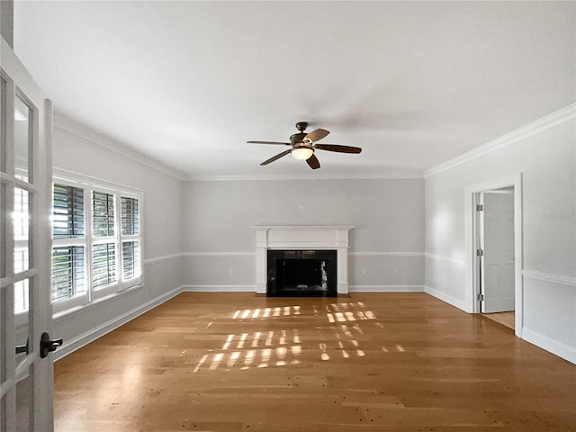 unfurnished living room with wood-type flooring, ornamental molding, and ceiling fan