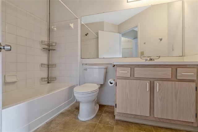 full bathroom with tiled shower / bath, vanity, tile patterned floors, and toilet