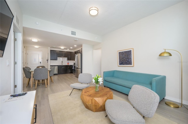 living room with light hardwood / wood-style flooring