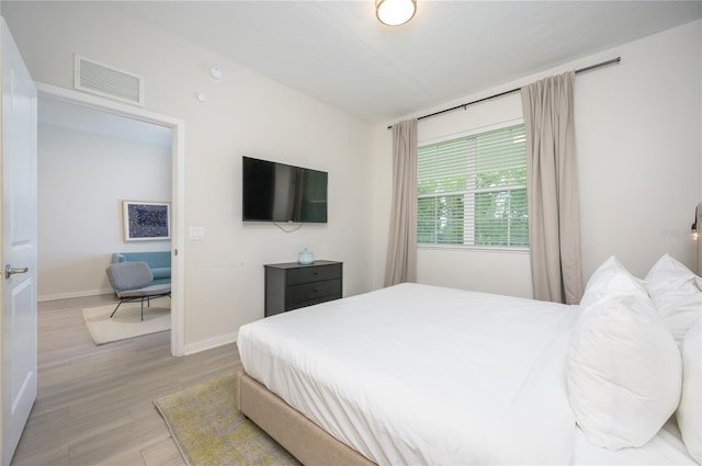 bedroom with light hardwood / wood-style flooring