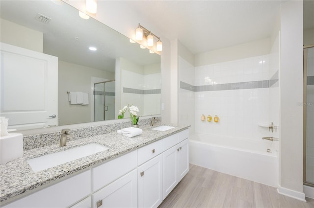 bathroom featuring wood-type flooring, separate shower and tub, and vanity