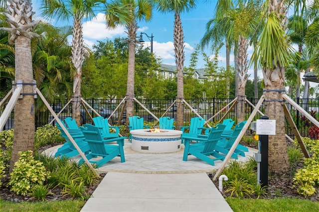 view of home's community with a fire pit and a patio area