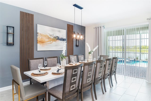 dining space with a notable chandelier and light tile patterned flooring