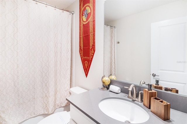 bathroom with vanity, toilet, and walk in shower