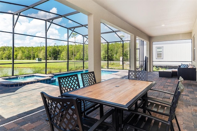 view of patio with a swimming pool with hot tub and a lanai