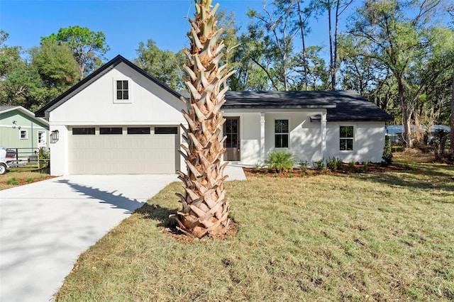 view of front of property featuring a garage and a front yard