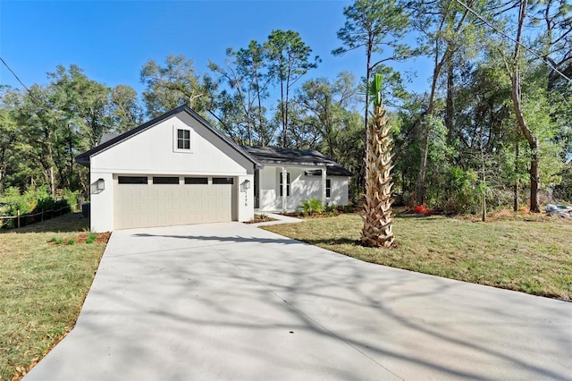 view of front of property featuring a garage and a front lawn