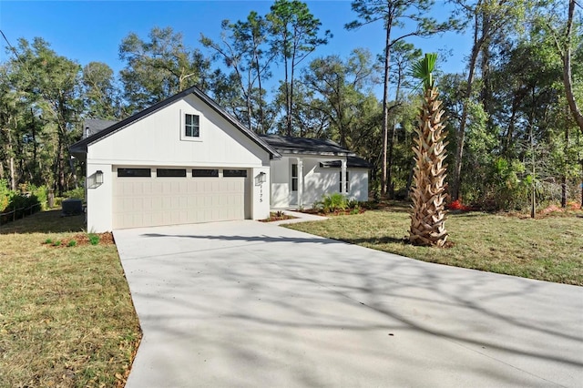 view of front of house featuring a garage and a front lawn