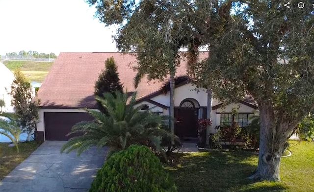 12017 Fambridge, Orlando, FL 32837 - view of front of property with a garage and a front lawn