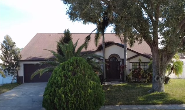 view of front of property with a garage and a front yard