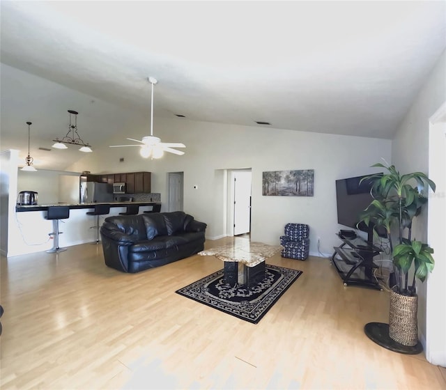 living room with lofted ceiling, light hardwood / wood-style floors, and ceiling fan