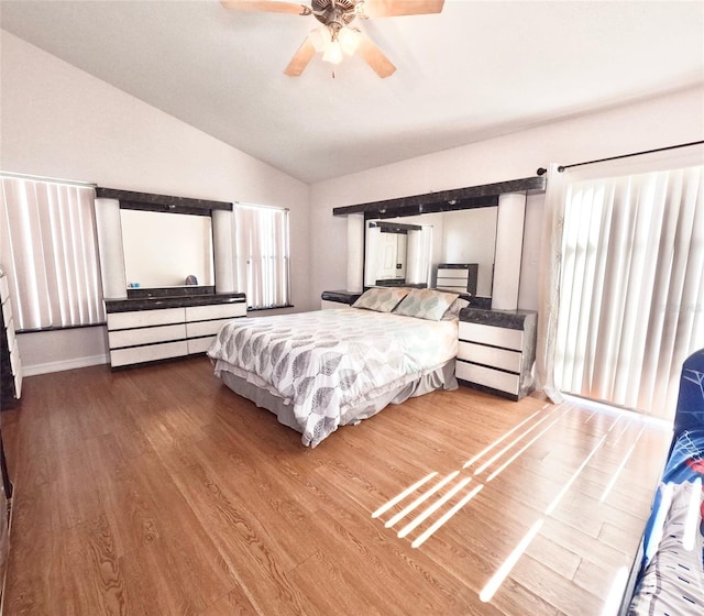 bedroom featuring lofted ceiling, hardwood / wood-style floors, and ceiling fan