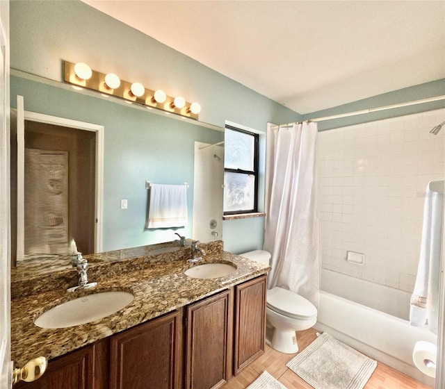 full bathroom featuring vanity, wood-type flooring, shower / bath combination with curtain, and toilet