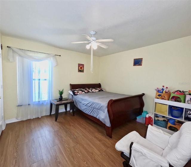 bedroom with hardwood / wood-style flooring and ceiling fan