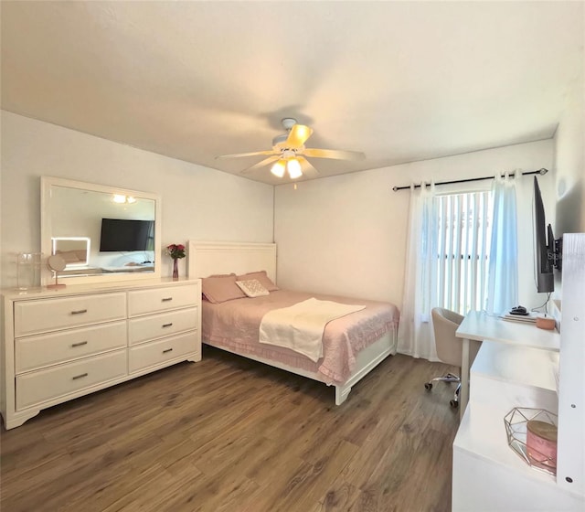 bedroom with dark hardwood / wood-style flooring and ceiling fan