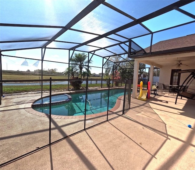 view of swimming pool featuring a water view, an in ground hot tub, a lanai, and a patio area