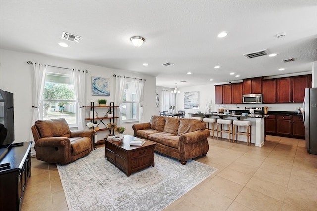 3270 Mt Vernon Way, Kissimmee, FL 34741 - living room with light tile patterned floors, recessed lighting, and visible vents