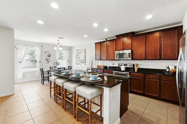 3270 Mt Vernon Way, Kissimmee, FL 34741 - kitchen with stainless steel appliances, recessed lighting, a sink, and a kitchen bar