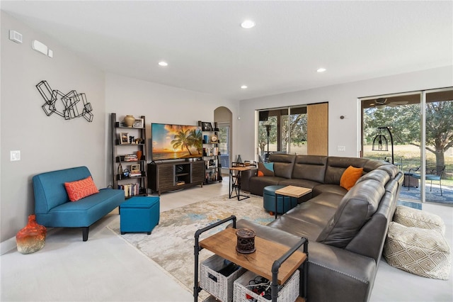 living room featuring arched walkways and recessed lighting