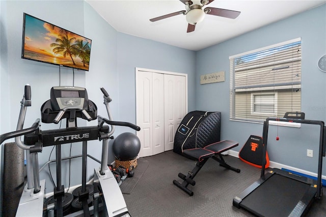 workout area featuring ceiling fan and baseboards