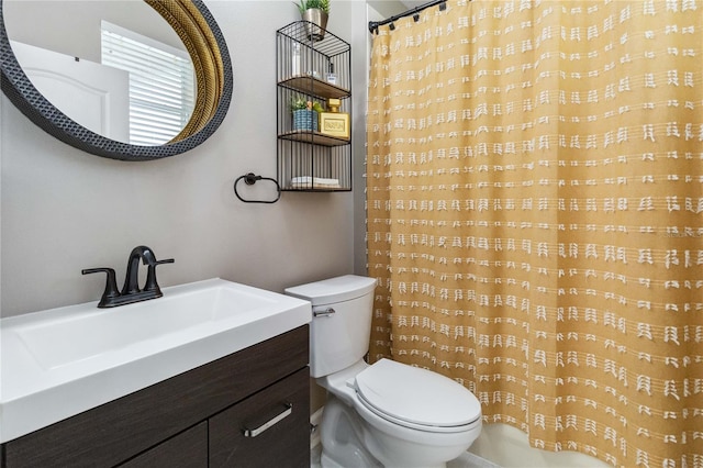 bathroom featuring curtained shower, vanity, and toilet