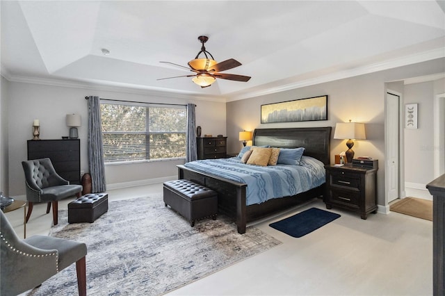 bedroom featuring light carpet, baseboards, a tray ceiling, and ornamental molding