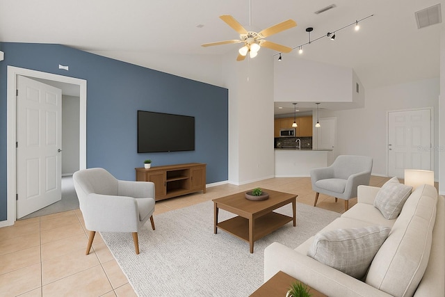 3304 Kelsey Ln, Saint Cloud, FL 34772 - living room featuring lofted ceiling, light tile patterned floors, a ceiling fan, track lighting, and baseboards