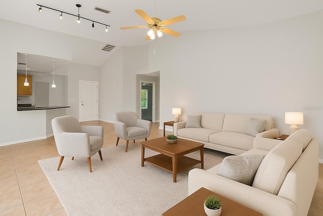3304 Kelsey Ln, Saint Cloud, FL 34772 - living area featuring light tile patterned flooring, a ceiling fan, rail lighting, baseboards, and lofted ceiling