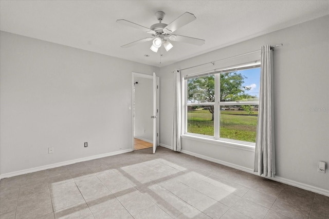3304 Kelsey Ln, Saint Cloud, FL 34772 - spare room with a ceiling fan, light tile patterned floors, and baseboards