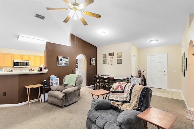 carpeted living room featuring vaulted ceiling and ceiling fan