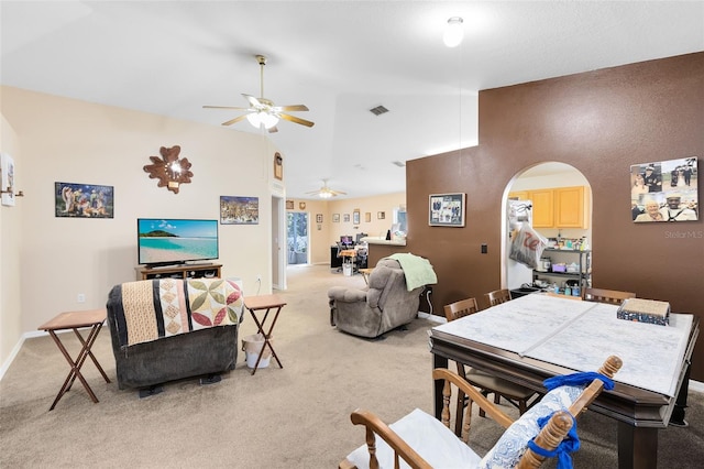 carpeted living room featuring high vaulted ceiling and ceiling fan