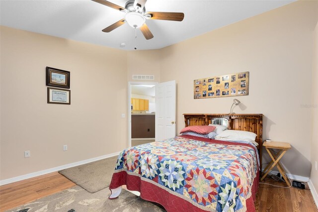 bedroom with wood-type flooring and ceiling fan