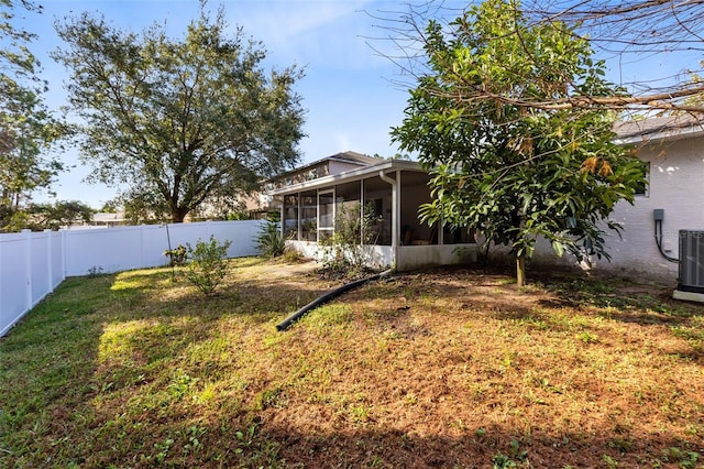 view of yard featuring central AC and a sunroom