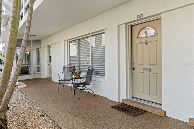 view of exterior entry with a porch