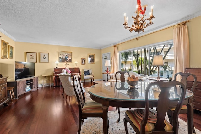 dining room with ornamental molding, an inviting chandelier, a textured ceiling, and dark hardwood / wood-style flooring