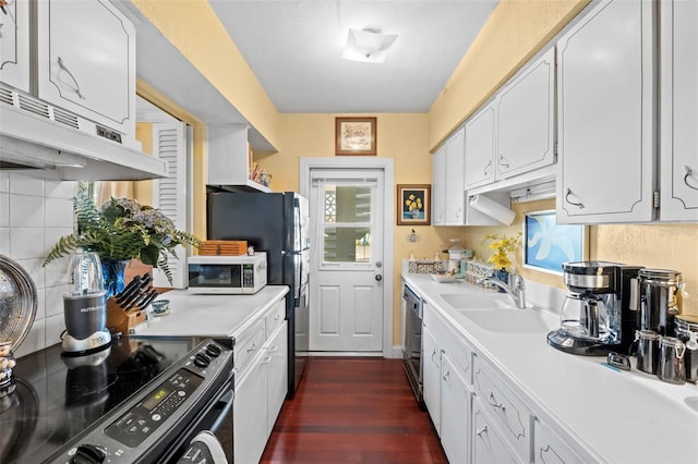 kitchen with range with electric stovetop, sink, stainless steel dishwasher, and white cabinets