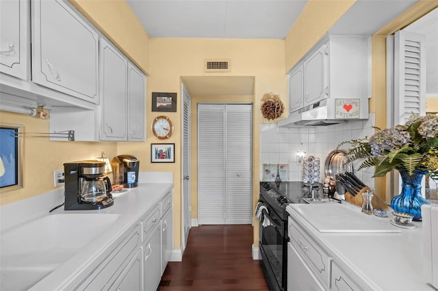 kitchen with sink, white cabinetry, electric range, dark hardwood / wood-style floors, and tasteful backsplash