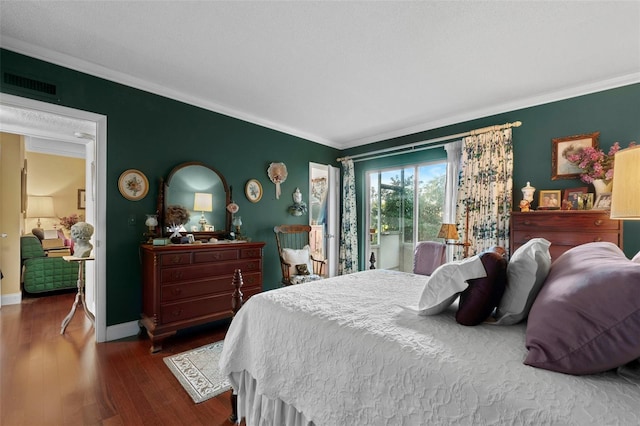 bedroom with dark wood-type flooring and ornamental molding