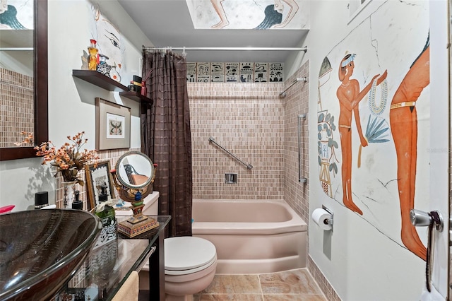 full bathroom with sink, shower / tub combo with curtain, and toilet