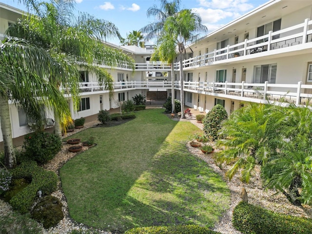 view of property's community with a lawn