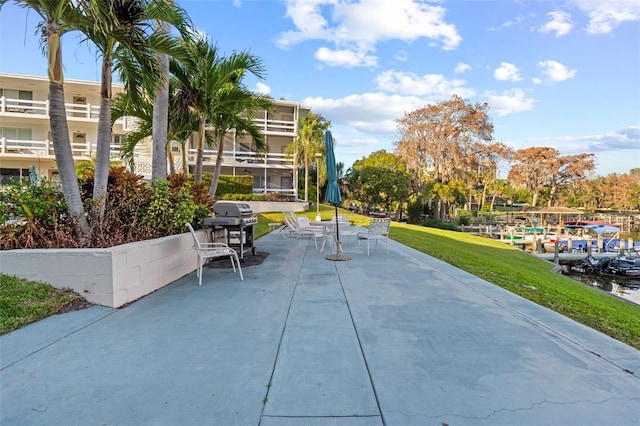 view of home's community with a patio and a lawn