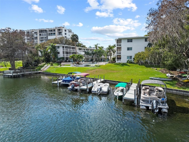 view of dock with a water view and a lawn