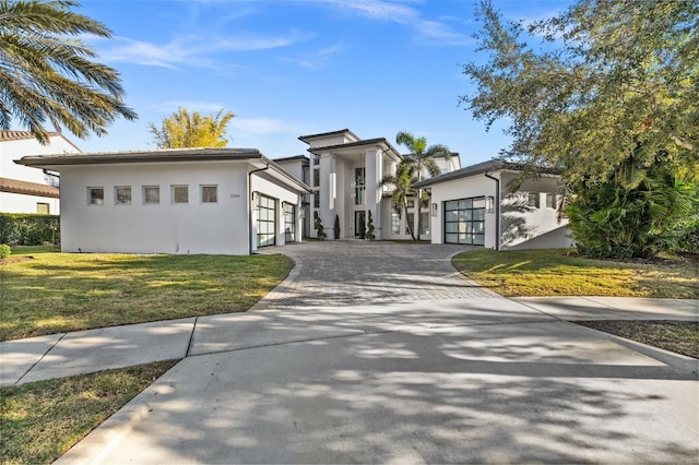 view of front of house featuring a garage and a front lawn