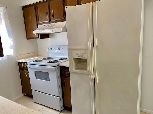 kitchen featuring ventilation hood, light tile patterned flooring, and white appliances