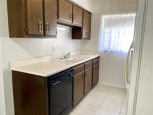 kitchen with sink, light tile patterned floors, dark brown cabinets, black dishwasher, and white refrigerator