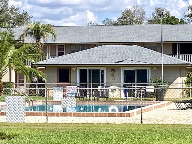 rear view of house featuring a yard