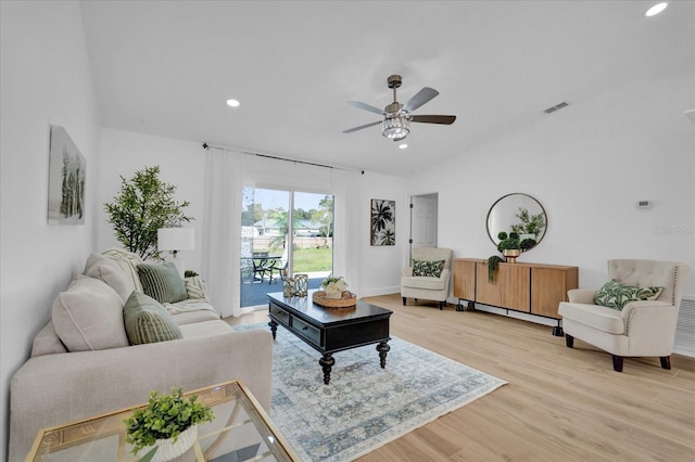 living room featuring vaulted ceiling, ceiling fan, and light wood-type flooring