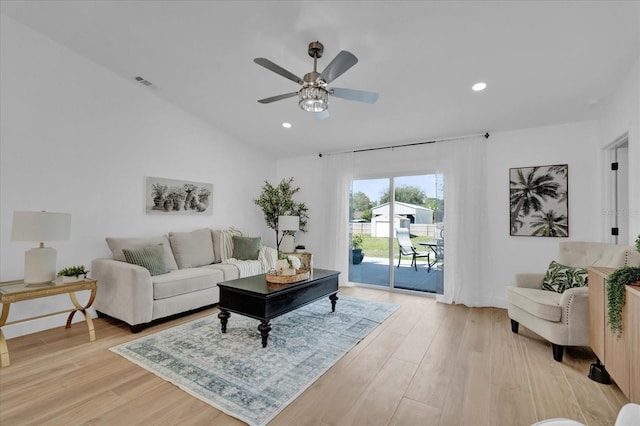 living room featuring vaulted ceiling, light hardwood / wood-style floors, and ceiling fan