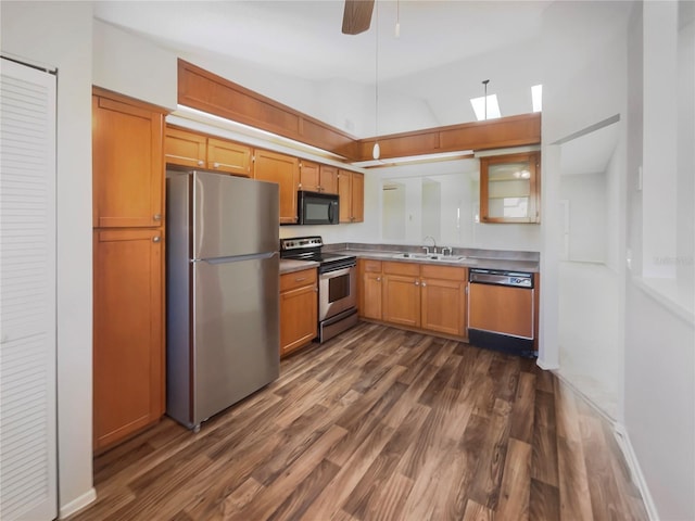 kitchen with sink, ceiling fan, appliances with stainless steel finishes, dark hardwood / wood-style flooring, and vaulted ceiling