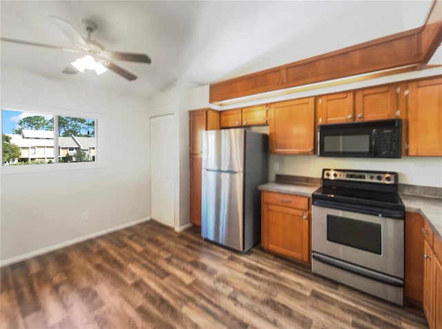 kitchen with ceiling fan, appliances with stainless steel finishes, lofted ceiling, and dark hardwood / wood-style flooring